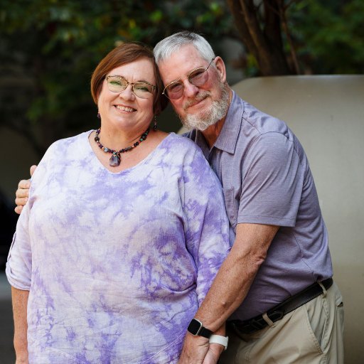 PDSA ITP Couple Wearing Purple PDSA Sign
